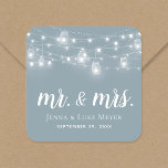 Rustic String Lights Mr. and Mrs. Wedding Monogram Square Sticker<br><div class="desc">Custom printed stickers personalised with your Mr. and Mrs. monogram and wedding date, perfect for wedding favour labels, welcome bags or envelope seals with your invitations. The design features glowing string lights and mason jars on a dusty blue background. Use the design tools to choose any background colour, change the...</div>