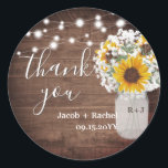 Rustic Sunflowers Mason Jar Wedding Thank You Classic Round Sticker<br><div class="desc">This wedding sticker design features pretty painted sunflowers and string lights on a rustic dark wood background. Click the customise button for more flexibility in modifying the text. Variations of this design, different paper types, as well as coordinating products are available in our shop, zazzle.com/store/doodlelulu. Contact us if you need...</div>