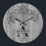 Rustic Wood Farmhouse Family Name Monogrammed Large Clock<br><div class="desc">Rustic Wood Farmhouse Family Name Monogrammed Clock design with floral elements. A warm and charming wall clock featuring a beautiful rustic wood grain texture adorned with delicate floral accents, your custom family name, and monogram in classic farmhouse typography. Perfect for adding a cozy country feel with a touch of botanical...</div>