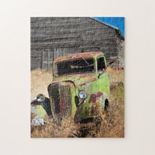 Rusting car in front of abandoned farm jigsaw puzzle