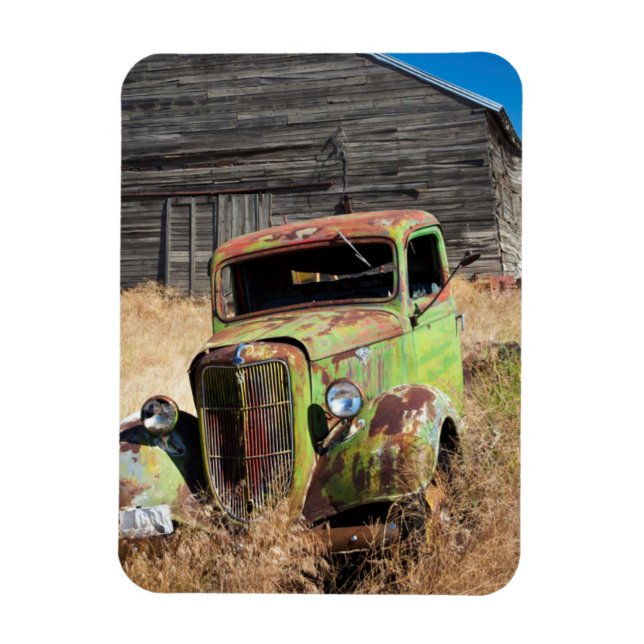 Rusting car in front of abandoned farm magnet (Vertical)