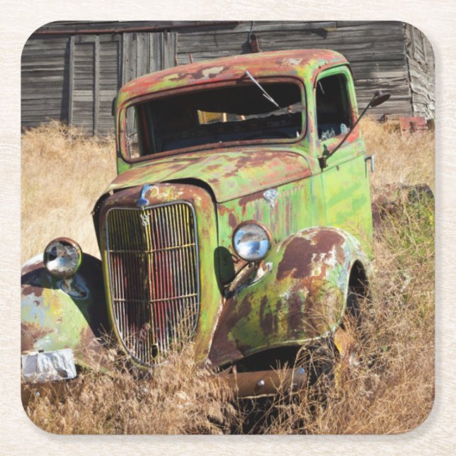 Rusting car in front of abandoned farm square paper coaster (Front)