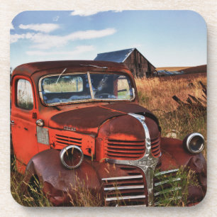 Rusting orange Dodge truck with abandoned farm Coaster