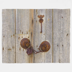 Rusty vintage old iron padlock on a wooden door _. fleece blanket