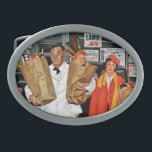 Sack Full of Trouble Oval Belt Buckle<br><div class="desc">Artist: Richard Sargent | Exasperated clerk carrying boy out of store in sack</div>