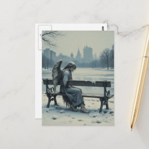 Sad angel sitting on a park bench postcard