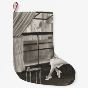 Sad woman staring out window1940s, woman, vintage, small christmas stocking
