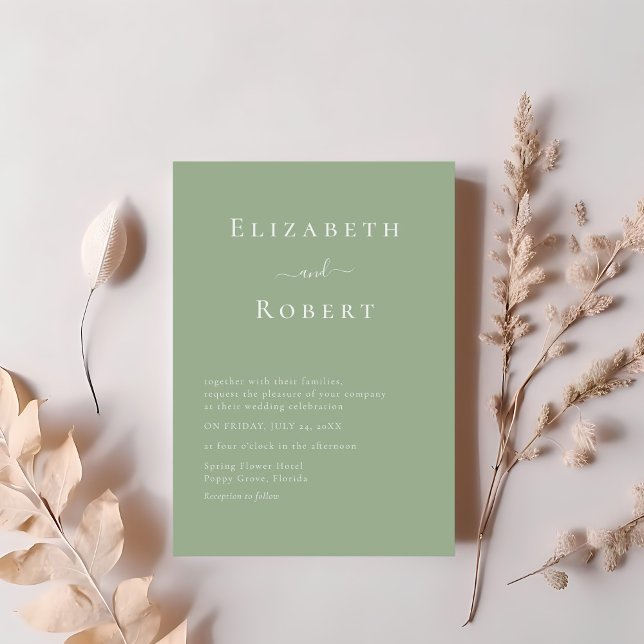 Sage Green Modern Minimalist Script Wedding Invitation (Sage Green Modern Minimalist Script Wedding Invitation on a table with blush pink flowers.)