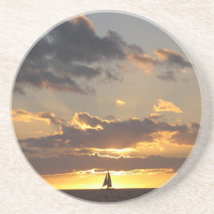 Sail boat at sunset coaster