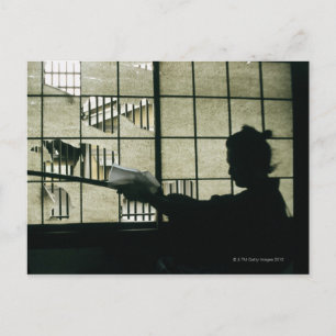 Samurai warrior cleaning a sword postcard