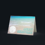 Sand Dollar Beach Tropical Christmas Cards<br><div class="desc">Tropical beach and sand dollar Christmas cards.  Pretty turquoise and aqua blue water is the background for chunky,  open font style greeting.  Customize the text on the front and inside.  A single white sand dollar,  on a sandy beach,  decorates the front and is the background for text inside.</div>