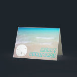 Sand Dollar Beach Tropical Christmas Cards<br><div class="desc">Tropical beach and sand dollar Christmas cards.  Pretty turquoise and aqua blue water is the background for chunky,  open font style greeting.  Customize the text on the front and inside.  A single white sand dollar,  on a sandy beach,  decorates the front and is the background for text inside.</div>