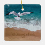 Sand Writing Beach Our First Christmas in Florida Ceramic Ornament<br><div class="desc">Nautical Boutique Co.'s personalised sand writing beach ornament features a watercolor painting of the beach with seagull flying overhead and your custom writing in the sand. "First Christmas in Florida" may be personalised, and, of course, the year may be changed, as well. The reverse side features your favourite photo and...</div>