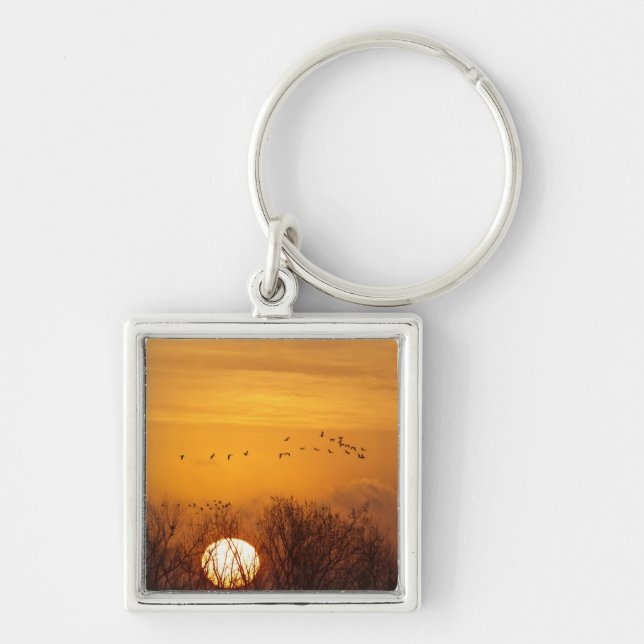 Sandhill cranes silhouetted aginst rising sun key ring (Front)