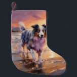 Sandy Australian Shepherd Dog on Beach Sunset  Small Christmas Stocking<br><div class="desc">Immerse yourself in the tranquil beauty of our "Sandy Paws and Sunset Hues" dog on beach sunset design. This captivating scene captures the essence of a perfect evening at the shore, with a loyal canine companion enjoying the golden sands and the breathtaking hues of the setting sun. Whether you're a...</div>