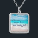 “Sandy Feet” Quote Blue Ocean & Hawaii Beach Photo Silver Plated Necklace<br><div class="desc">“Peace, love & sandy feet.” Remind yourself of the fresh salt smell of the ocean air whenever you wear this stunning, vibrantly-coloured photo charm necklace. This necklace comes in small, medium and large sizes, as well as both square and circle shapes. You can order this necklace in your choice of...</div>