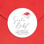 Santa Baby Christmas Baby Shower Classic Round Sticker<br><div class="desc">Cute stickers for your Christmas holiday season baby shower correspondence and party favours with "Santa Baby" in an elegant script with a heart swash and a watercolor illustration of a red Santa Claus hat. Personalise with the mother's name and shower date in simple modern typography.</div>