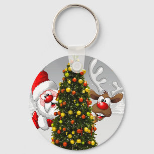 Santa claus and reindeer behind a christmas tree.j key ring