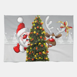 Santa claus and reindeer behind a christmas tree.j tea towel
