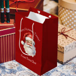 Santa Claus Personalised Red Kids Christmas Medium Gift Bag<br><div class="desc">Customise this nostalgic from Santa Claus gift bag with your own personalised text with your kids name in white script. This beautiful old fashioned drawing of Santa's red hat and white beard are the perfect holiday present bags for your children's presents under the tree on Christmas day.</div>