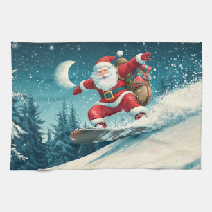 Santa delivering Christmas presents on a snowboard Tea Towel