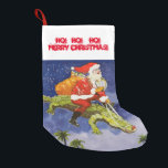 Santa Riding Gator Small Christmas Stocking<br><div class="desc">Santa Claus is riding on an alligator. Quite a sight. Santa, being quite resourceful, has trained alligators for Florida deliveries. Reindeer don't do well in the Florida climate, so he has taught gators to fly. Santa Claus is an amazing jolly old fellow, and this is how we do Christmas in...</div>