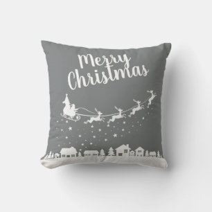 Santa's sleigh & reindeers flying above the city cushion