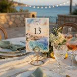 Santorini Wedding Table Numbers | Mediterranean<br><div class="desc">Guide your guests in style with these elegant Santorini-inspired wedding table numbers, designed to complement a romantic Mediterranean destination wedding. Featuring a soft watercolor coastal scene with ocean blues and warm sunset tones, these table numbers add a refined and cohesive touch to your reception decor. The clean layout with bold...</div>
