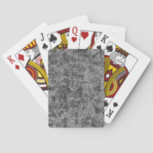 Scratches on a lightly spotted grey to black playing cards