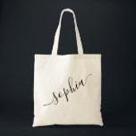 Script Name Personalised Modern Simple Tote Bag<br><div class="desc">Chic personalised labelled reusable canvas tote bag with custom name text for bridesmaid gifts, bachelorette parties, birthday favours, and girls trip keepsakes, and graduation gift for cute college and dorm room storage. Perfect for sports and hobby gear storage and transport. Colours and fonts are editable, just click “customise further” to...</div>