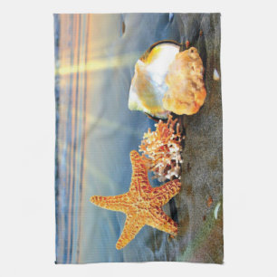 Sea shells and starfish on beach tea towel