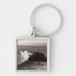 Sea waves crashing against rock key ring