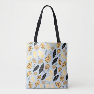 Seamless pattern of autumn leaves on a blue backgr tote bag