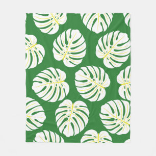 Seamless pattern of white monstera leaves on a dar fleece blanket