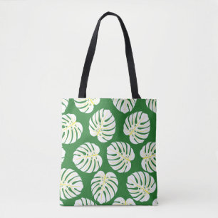Seamless pattern of white monstera leaves on a dar tote bag