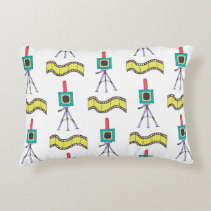 Seamless pattern with cameras and film strips on a decorative cushion