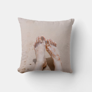 Selective focus photography of feet with tattoo on cushion