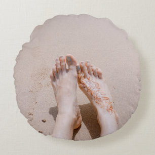 Selective focus photography of feet with tattoo on round cushion