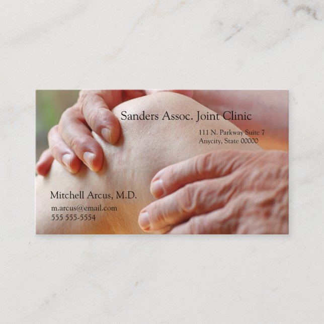 Senior examines an aching knee business card (Front)