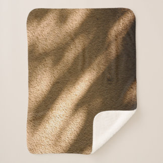 Shadow on brown carpeted floor sherpa blanket