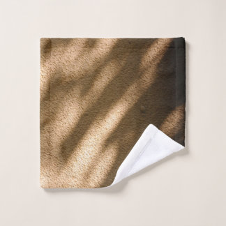 Shadow on brown carpeted floor wash cloth