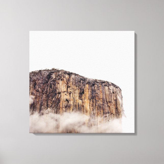 Sheer cliff rising above clouds canvas print (Front)