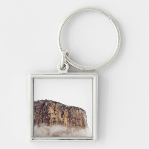 Sheer cliff rising above clouds key ring