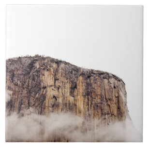 Sheer cliff rising above clouds tile