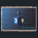 Shiny Blue Dreidel Throw Blanket<br><div class="desc">A modernistic, metallic blue dreidel against a dark, night-like background. Two of the Hebrew letters found on a dreidel, nun and shin, glow brightly. Add your own text.</div>