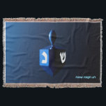 Shiny Blue Dreidel Throw Blanket<br><div class="desc">A modernistic, metallic blue dreidel against a dark, night-like background. Two of the Hebrew letters found on a dreidel, nun and shin, glow brightly. Hebrew text reading "Chag Chanukkah Sameach" (Happy Hanukkah) also appears in glowing blue and white.</div>