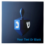Shiny Blue Dreidel Tile<br><div class="desc">A modernistic, metallic blue dreidel against a dark, night-like background. Two of the Hebrew letters found on a dreidel, nun and shin, glow brightly. Add your own text.</div>