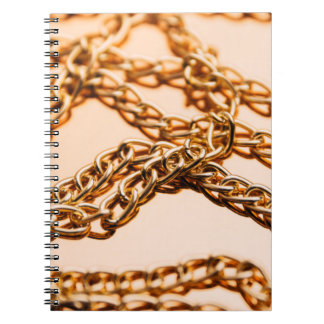 Shiny golden chains on reflective surface. Seamles Notebook