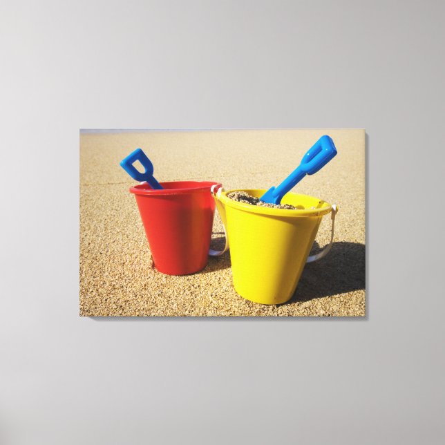 Shovels And Pails On Sandy Beach Canvas Print (Front)