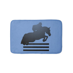 Show jumper clearing an obstacle. bath mat